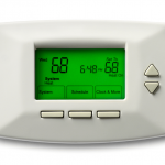 Close up of digital thermostat with time and temperature