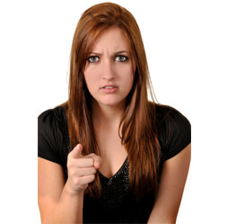 Female teenager pointing index finger sternly looking at camera