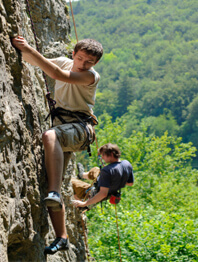 Two older boys rock climbing